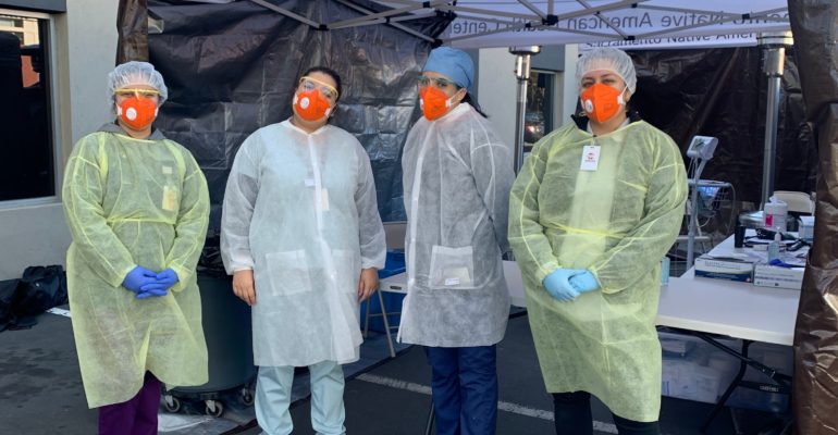SNAHC Staff standing in front of a SNAHC Triage Tent