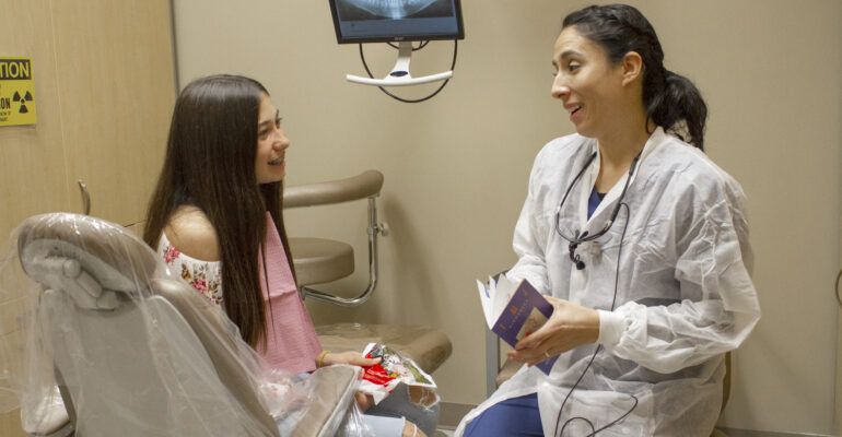 Dental hygenist with young patient